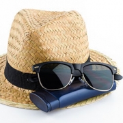 image of sunglasses sitting on a hat