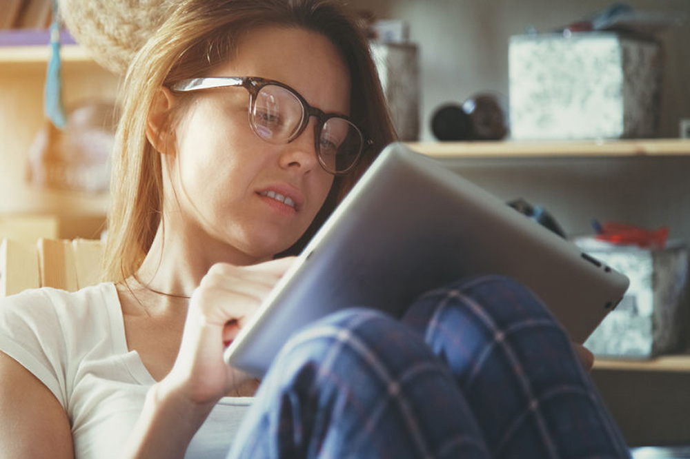 lady wearing glasses and using an ipad